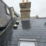 Full re-roof of a terraced property using Spanish natural slate, copper fixings, and dry-ridge detailing